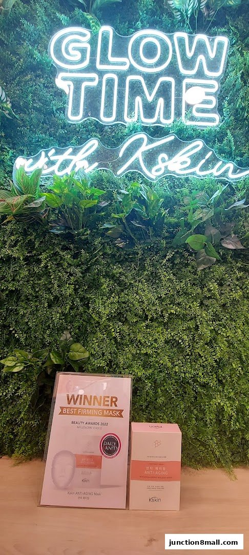 Kskin products displayed against a green wall with neon 'Glow Time' sign.