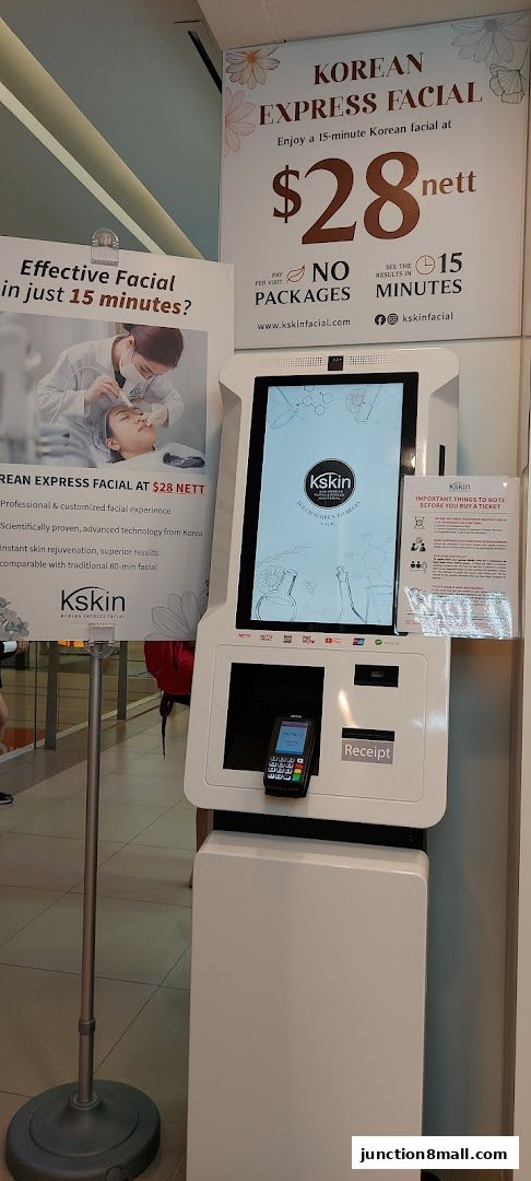 A Kskin Korean Express Facial kiosk with promotional signage and a payment terminal.