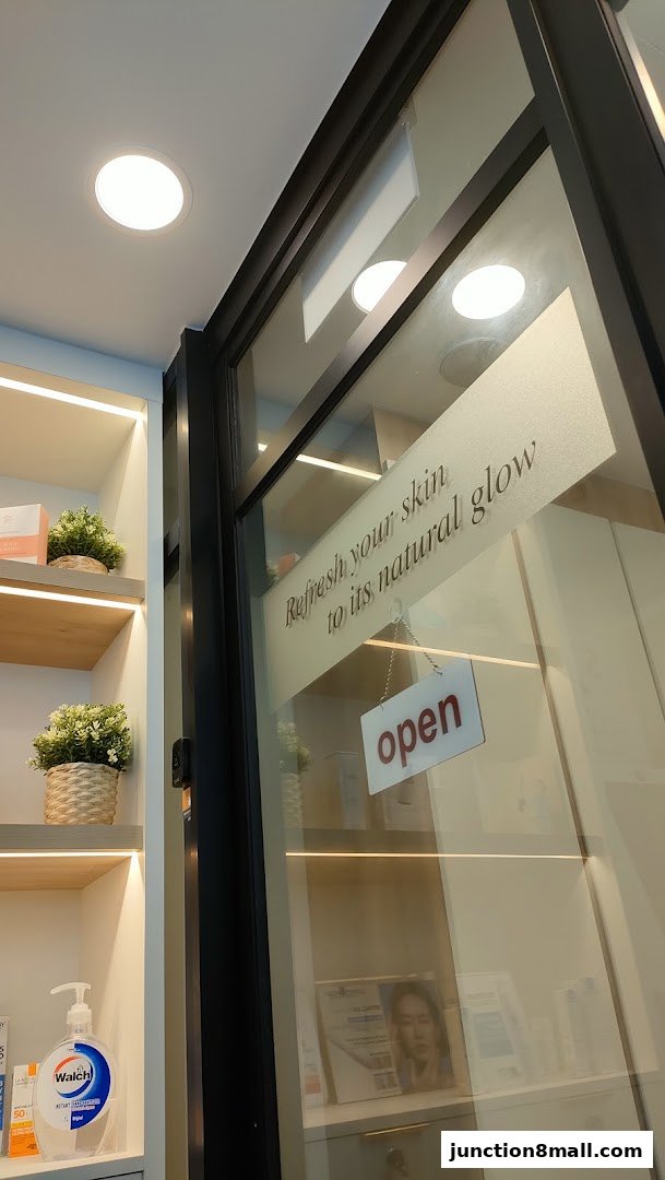 Shop entrance with shelves displaying skincare products and an 'open' sign.