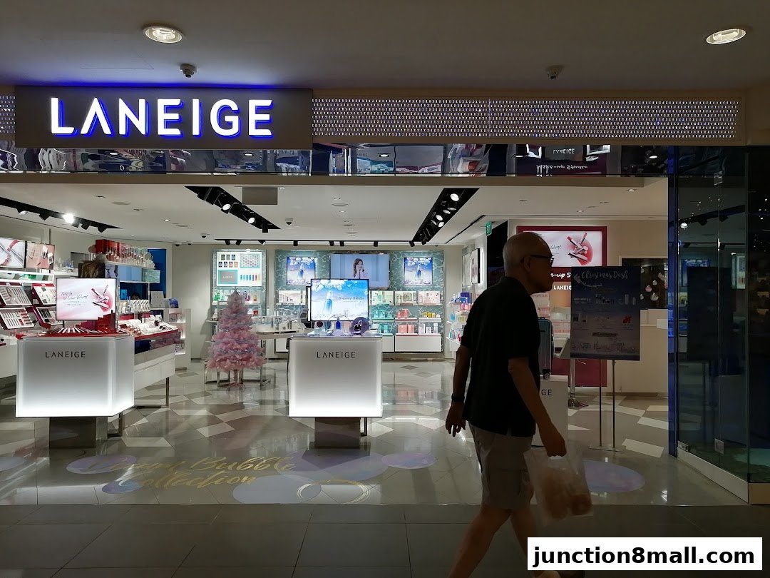 The entrance of a LANEIGE beauty store with displays of makeup and skincare products.