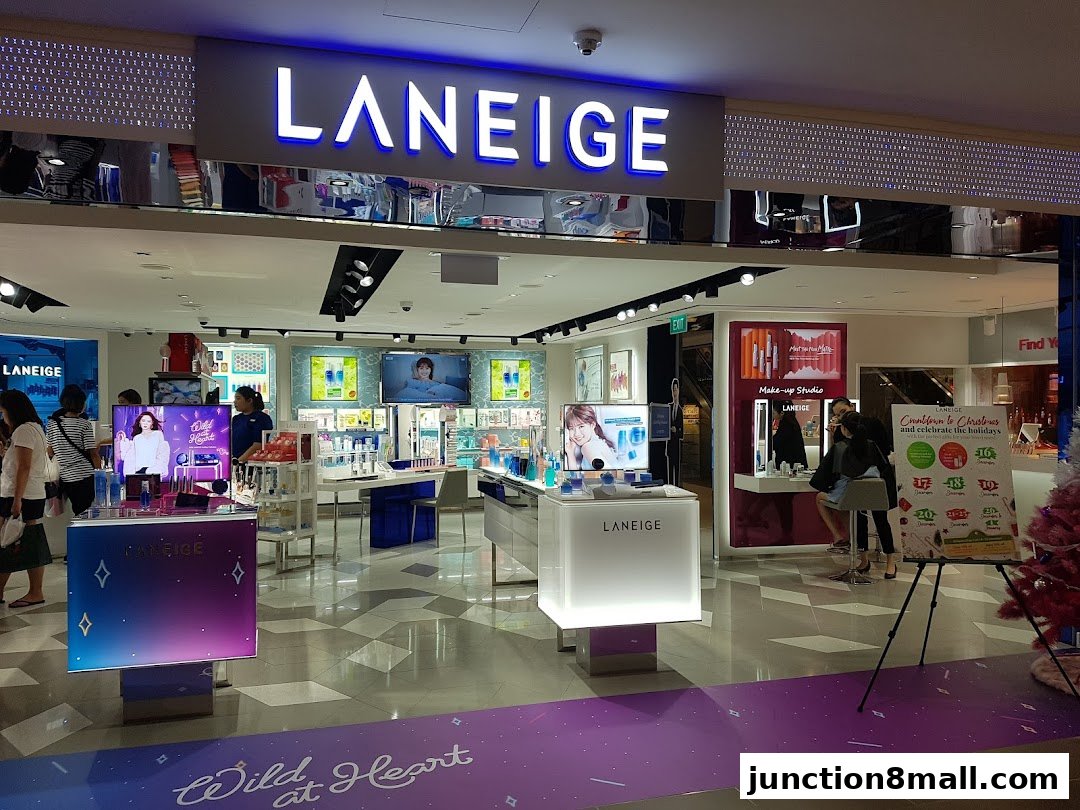 The LANEIGE beauty store entrance with displays of makeup and skincare products.