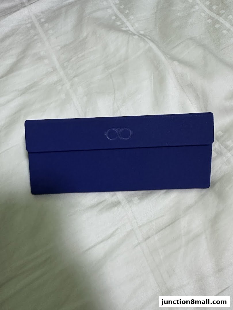 A closed, dark blue glasses case with an infinity symbol embossed on the lid.