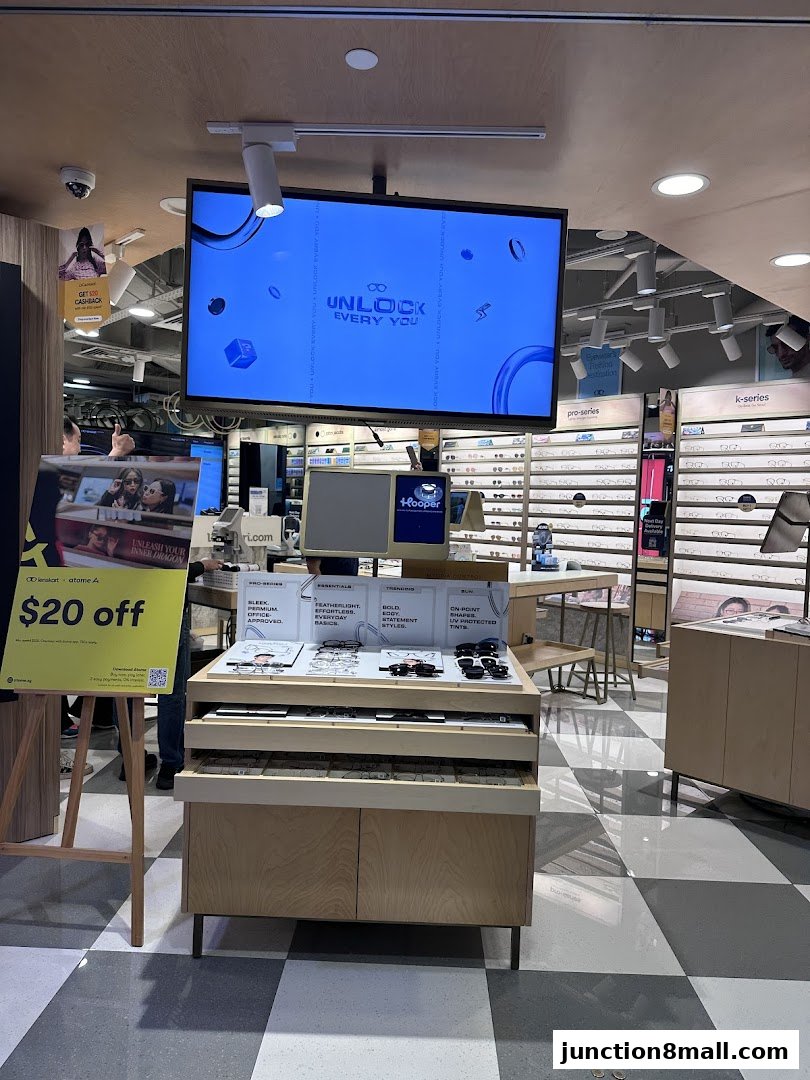 Interior of a Lenskart store showcasing various eyewear collections and a promotional offer.