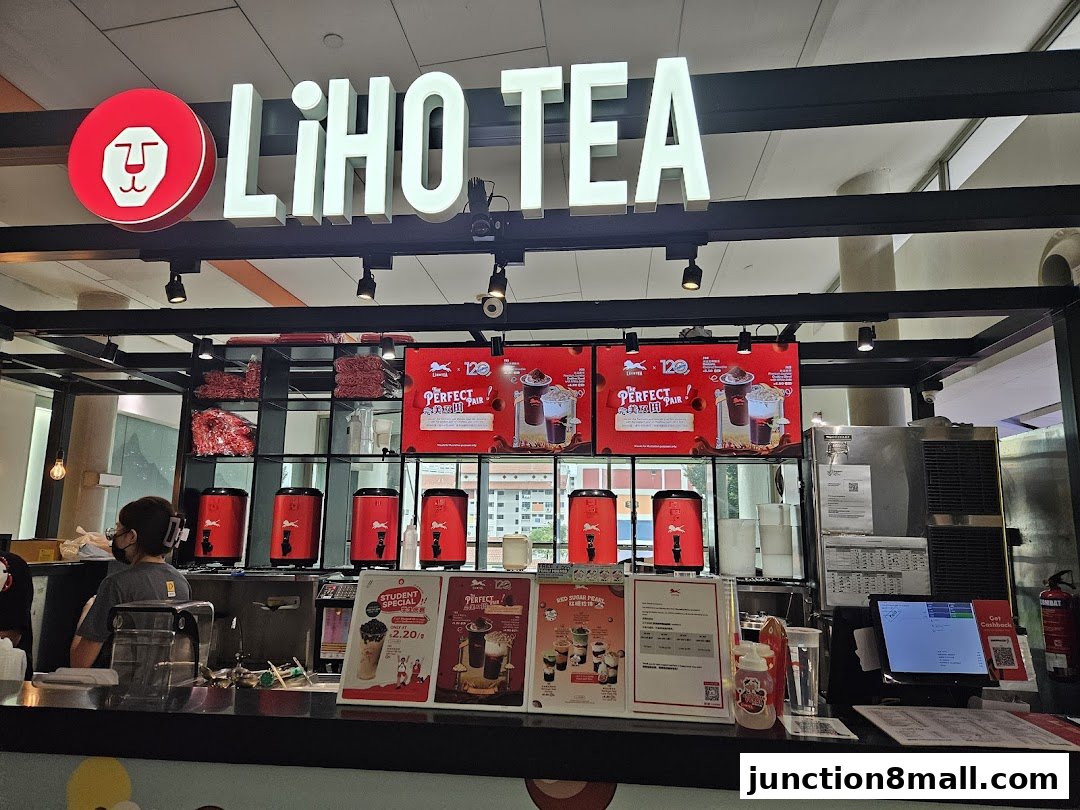 The LiHO TEA shop front with illuminated signage and beverage displays.