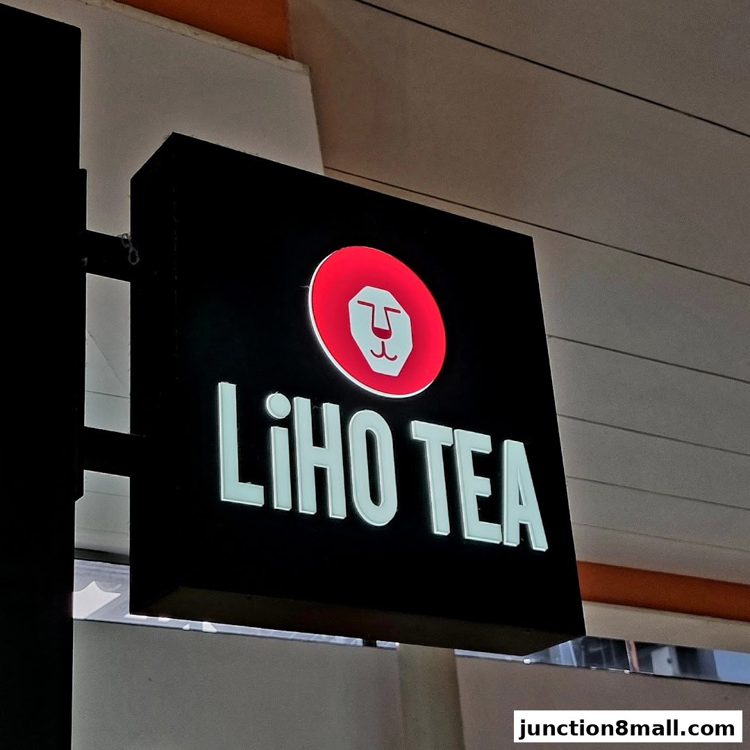 A lit sign for LiHO TEA featuring a lion logo and the brand name.