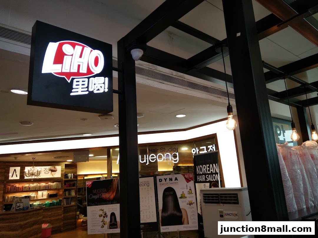 A LiHO TEA sign hangs above a salon with various hair products and promotions visible.