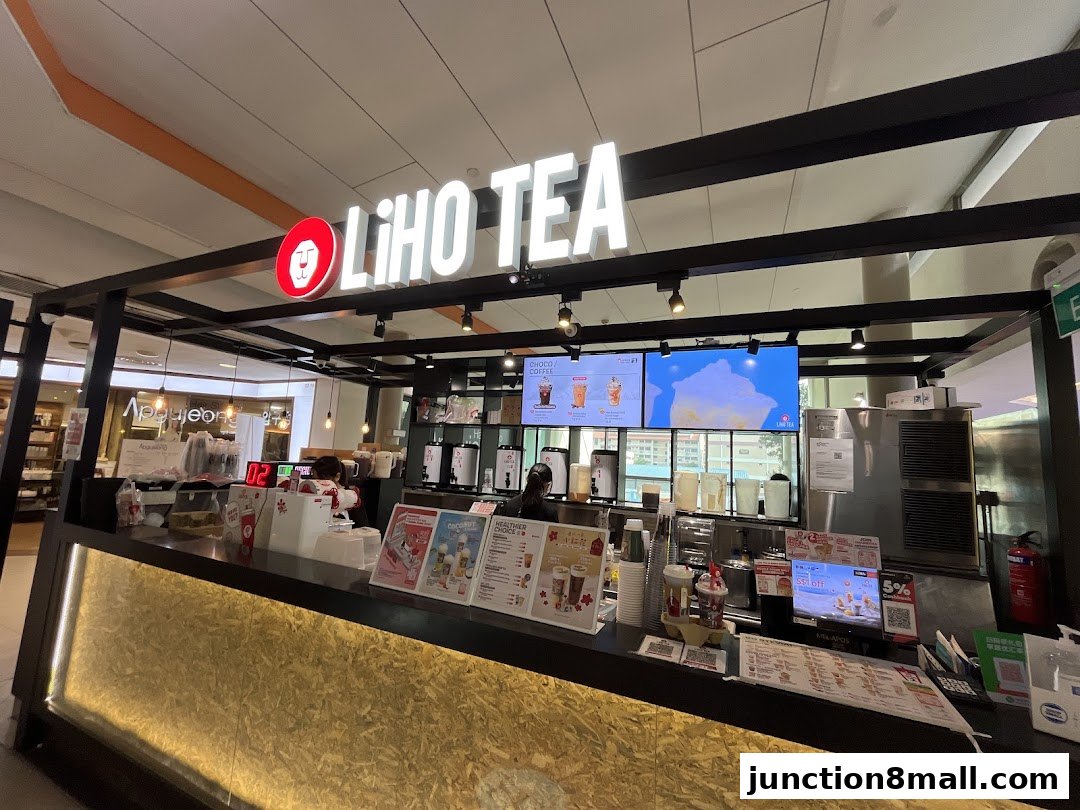 A LiHO TEA shop counter with digital menus and promotional displays.
