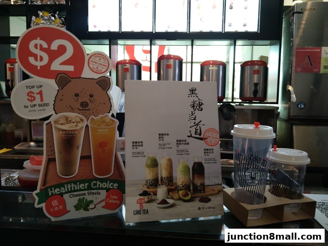 LiHO TEA shop counter with drinks, menu, and promotional signs.