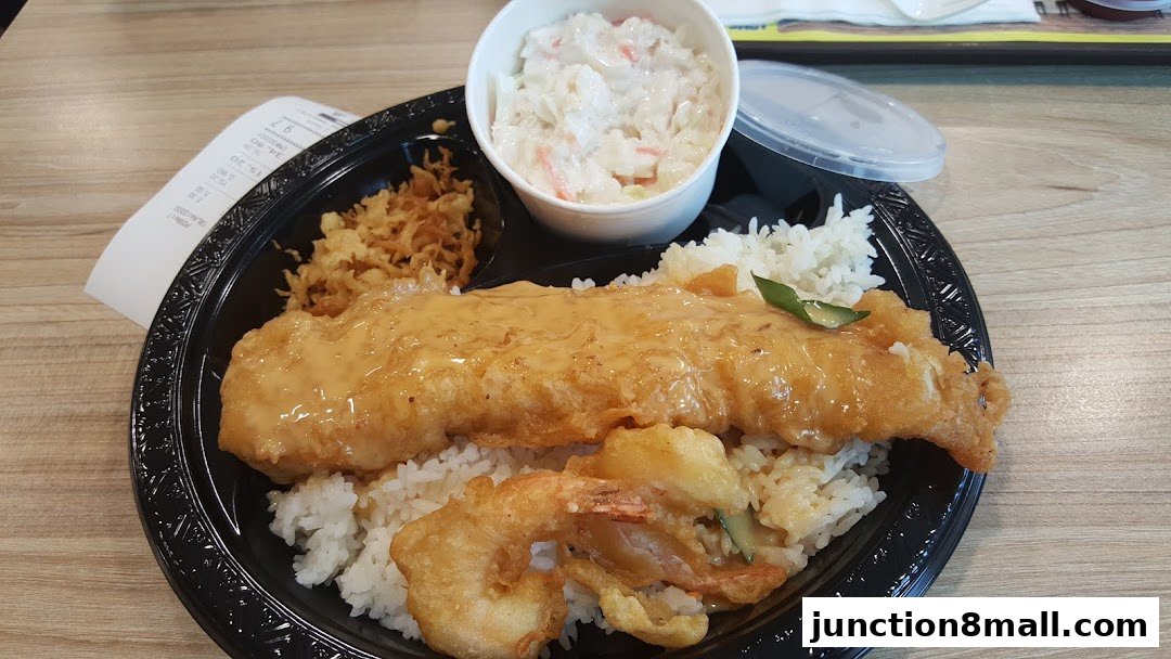 A Long John Silver's meal featuring fried fish, shrimp, rice, coleslaw, and crispy onions.