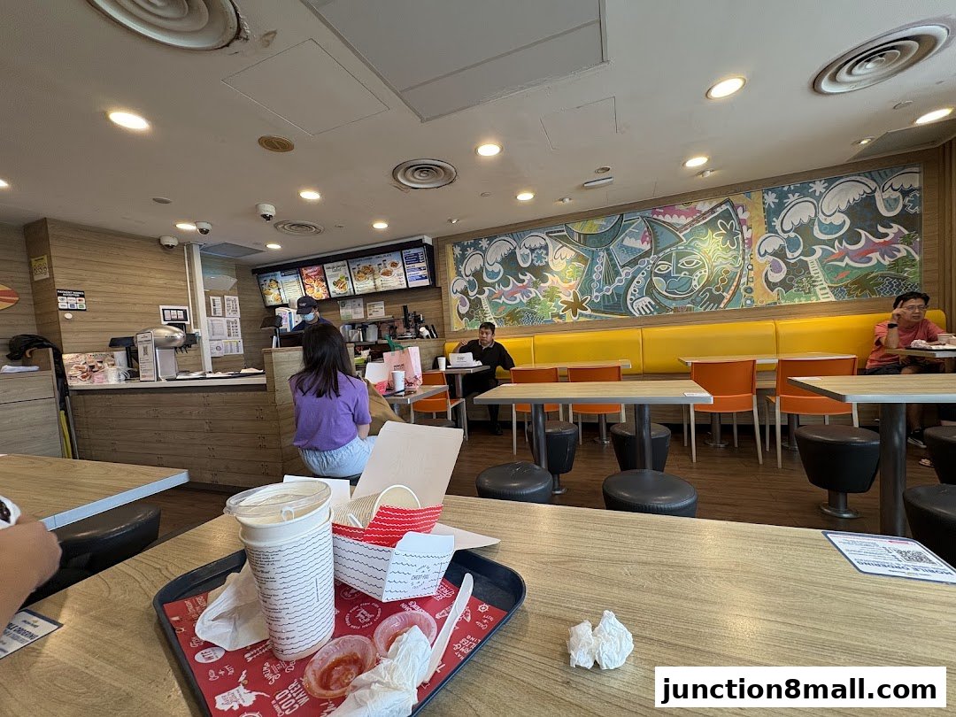 Interior of a Long John Silver's restaurant with customers and a colorful mural.