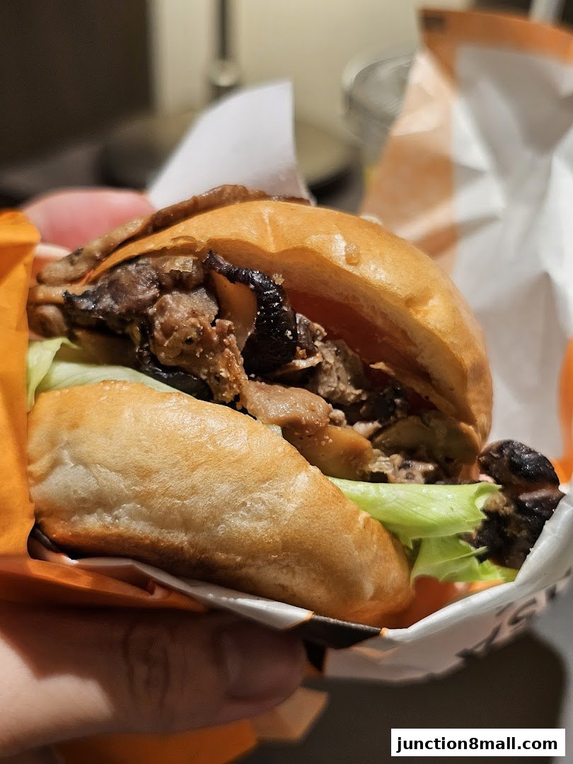 A close-up shot of a delicious-looking burger with fresh lettuce and mushrooms.