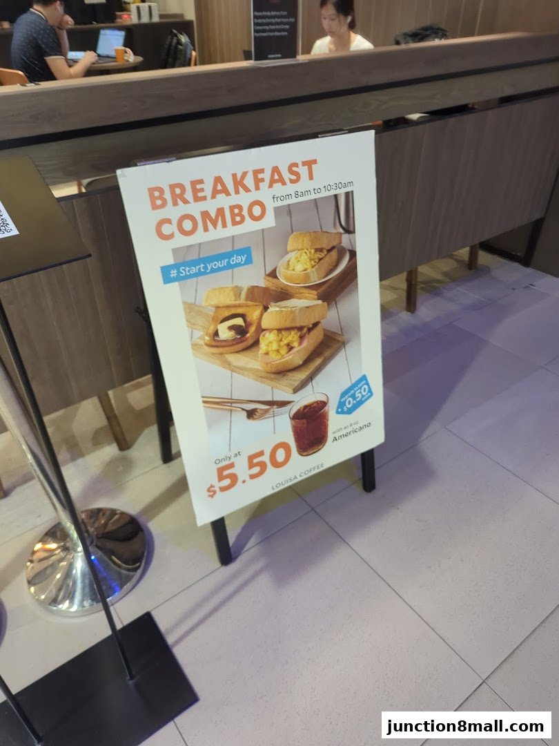 A sign advertising a breakfast combo deal at Louisa Coffee.