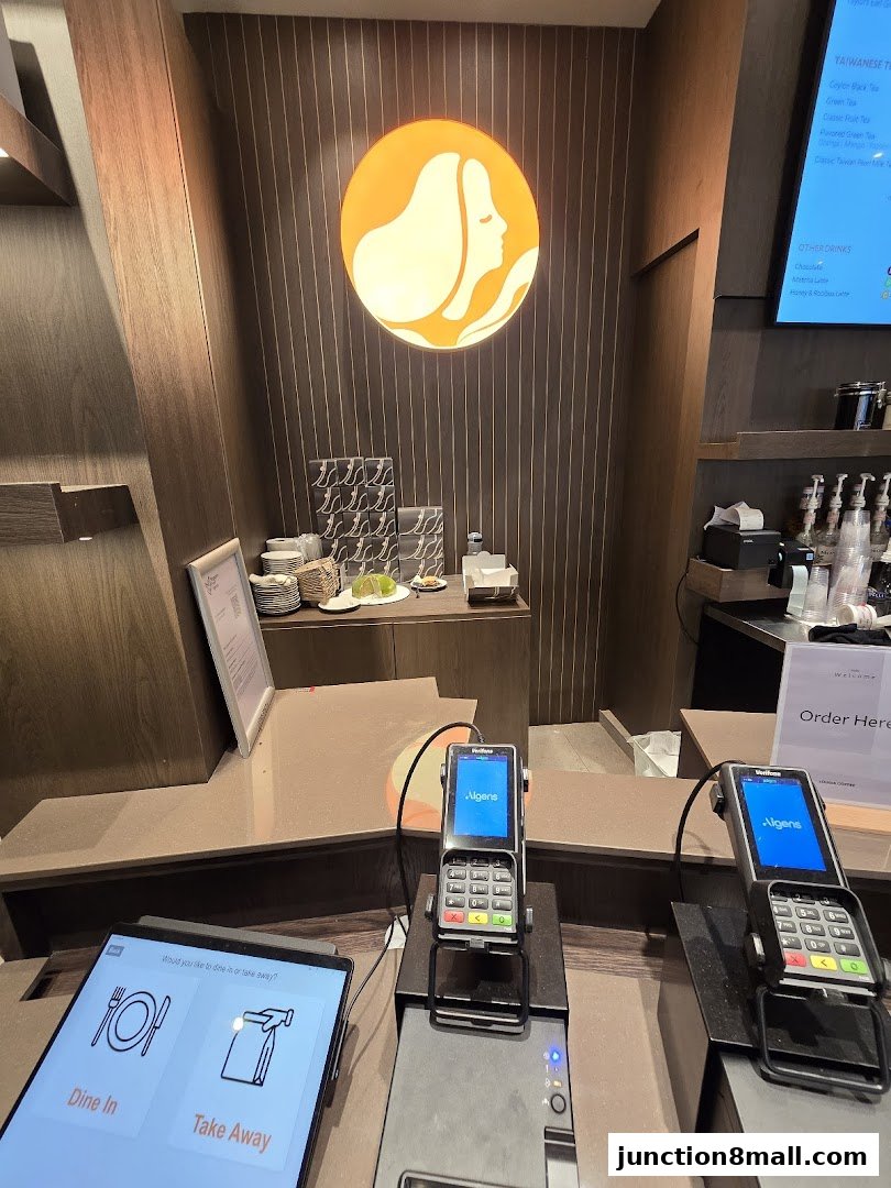 A counter at Louisa Coffee with payment terminals and a tablet for ordering.