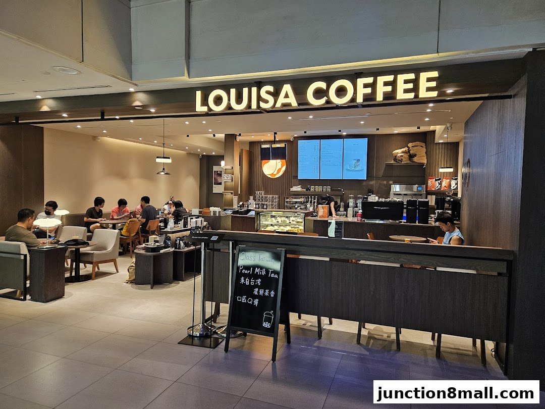 Interior view of Louisa Coffee shop with customers seated and staff behind the counter.