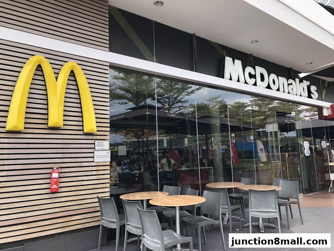 Exterior view of a McDonald's restaurant with its iconic golden arches and signage.