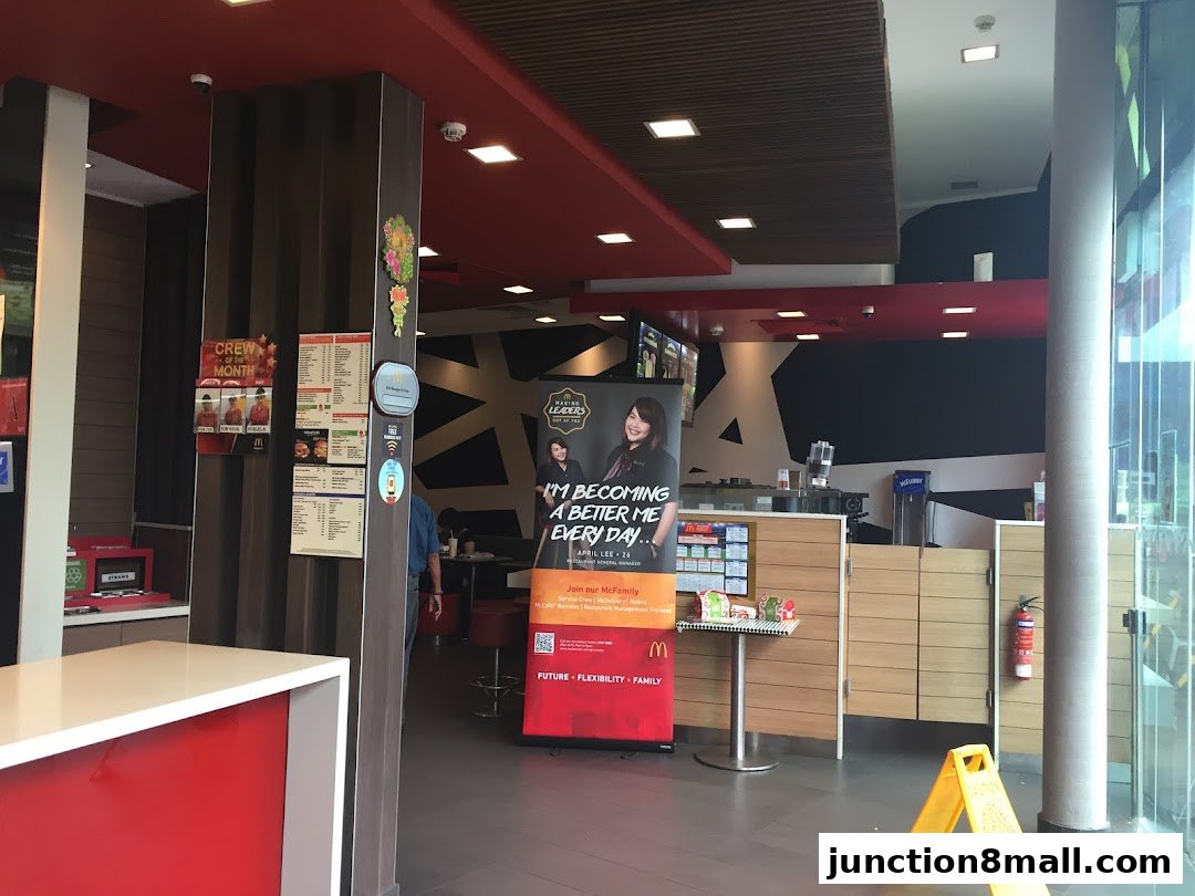 Interior view of a McDonald's restaurant with a counter, menus, and promotional banners.