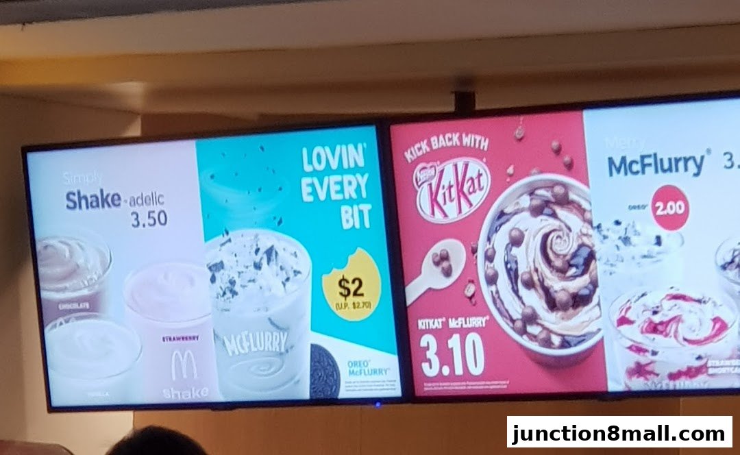 A digital menu board displaying various McFlurry and shake options with prices.