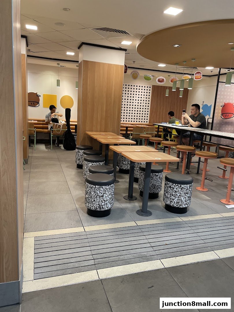 Interior view of a McDonald's restaurant with seating areas and customers.