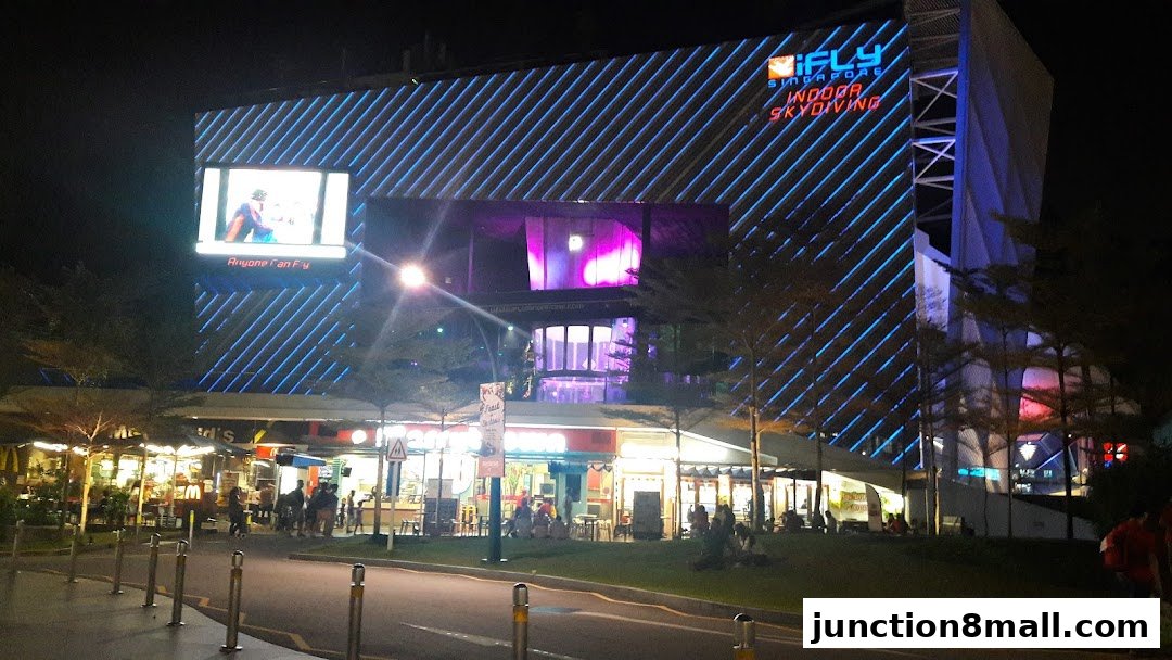 McDonald's Bishan Junction 8 at night, with the iFly Singapore building in the background.