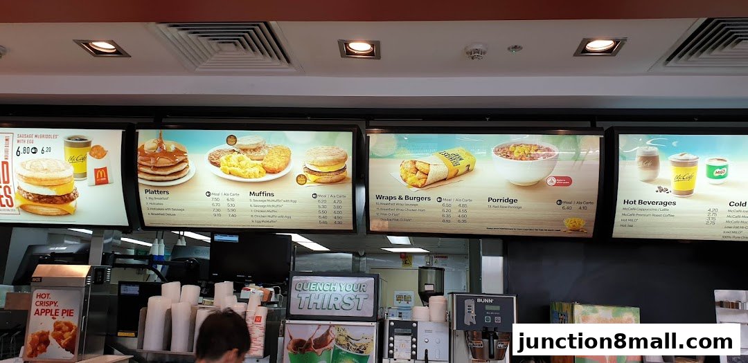 A McDonald's menu board displaying breakfast items, wraps, porridge, and beverages.