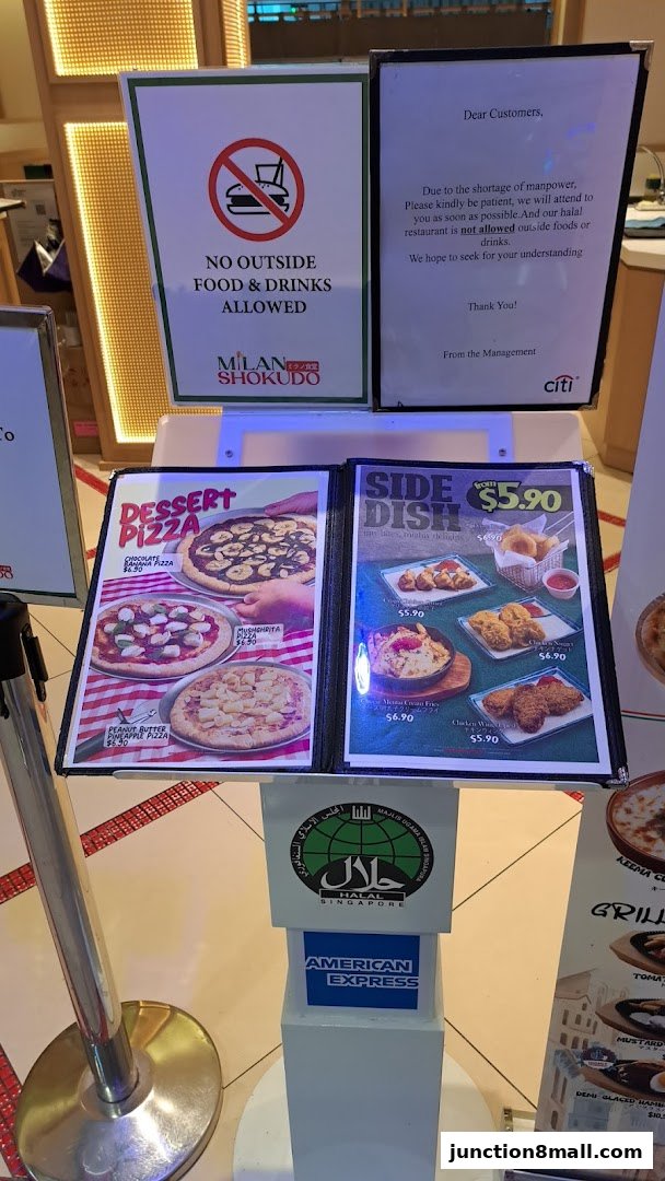 A menu display featuring dessert pizzas and side dishes, with a notice about manpower shortage.