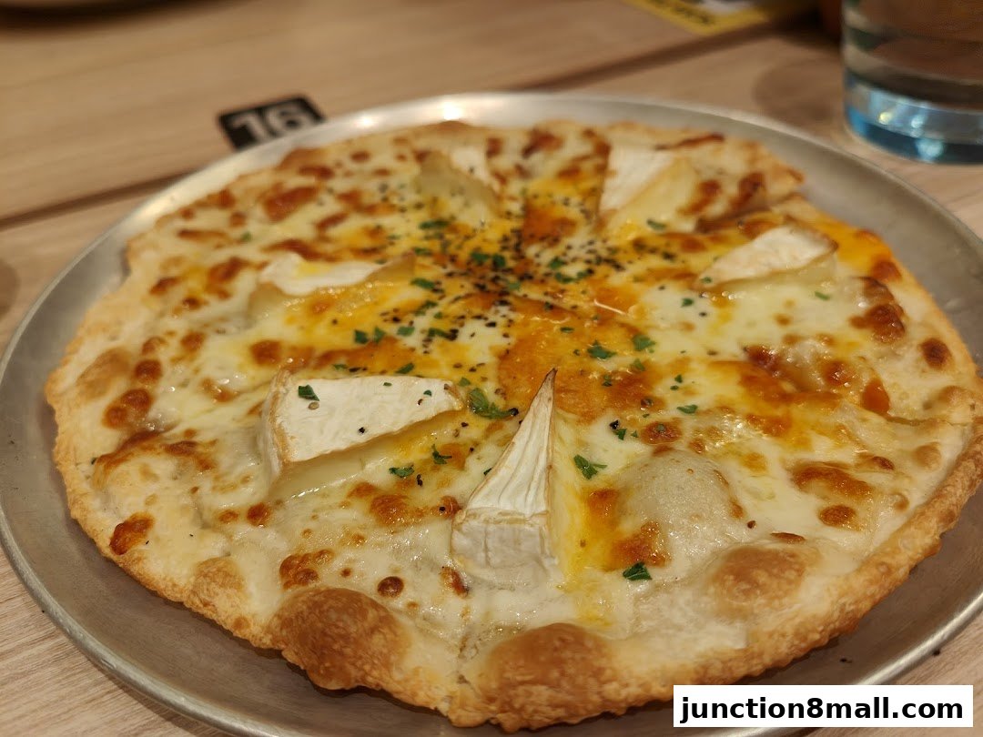 A close-up shot of a delicious cheese pizza with visible chunks of brie cheese.