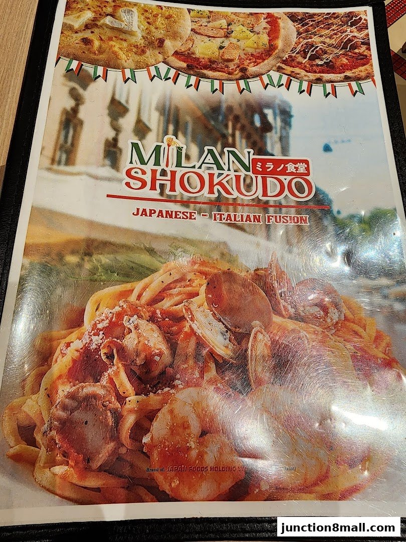 A menu from Milan Shokudo featuring Japanese-Italian fusion cuisine with images of pizza and pasta.