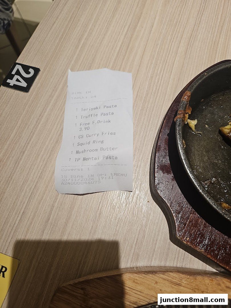 A receipt from Milan Shokudo Junction 8 showing food and drink orders.