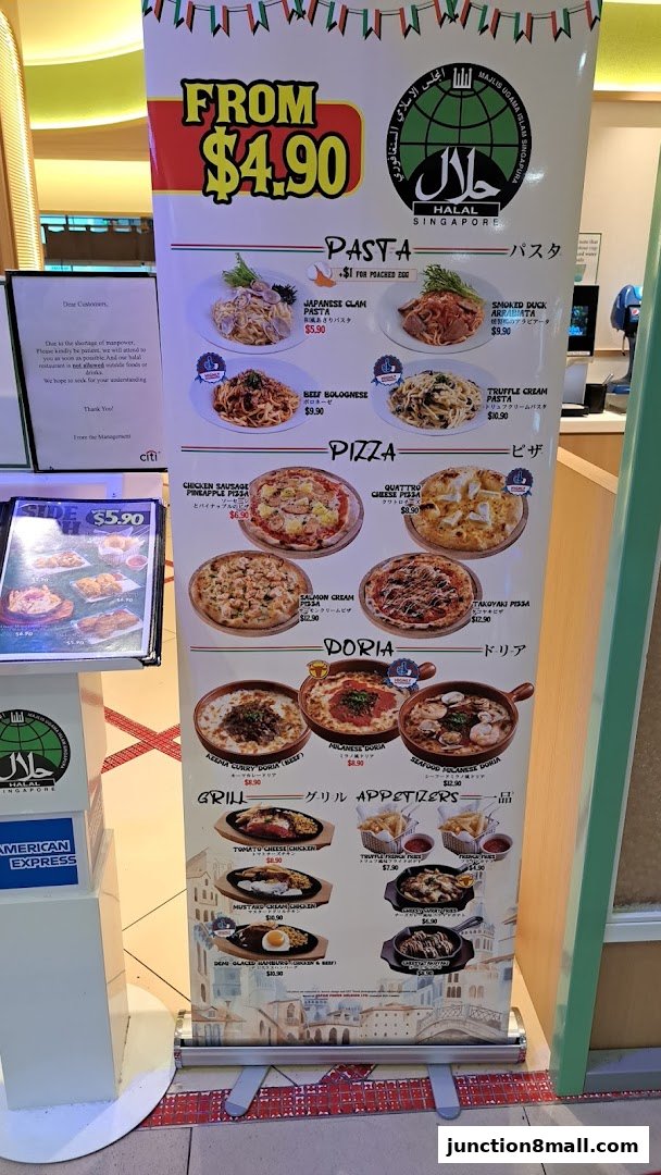 A menu display for Milan Shokudo Junction 8, featuring pasta, pizza, dorias, and grill items.