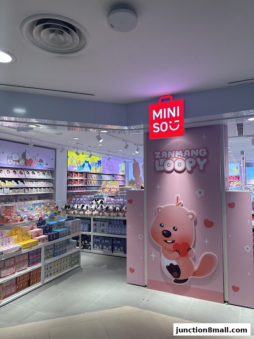 Interior view of a Miniso store with shelves stocked with various merchandise and character displays.