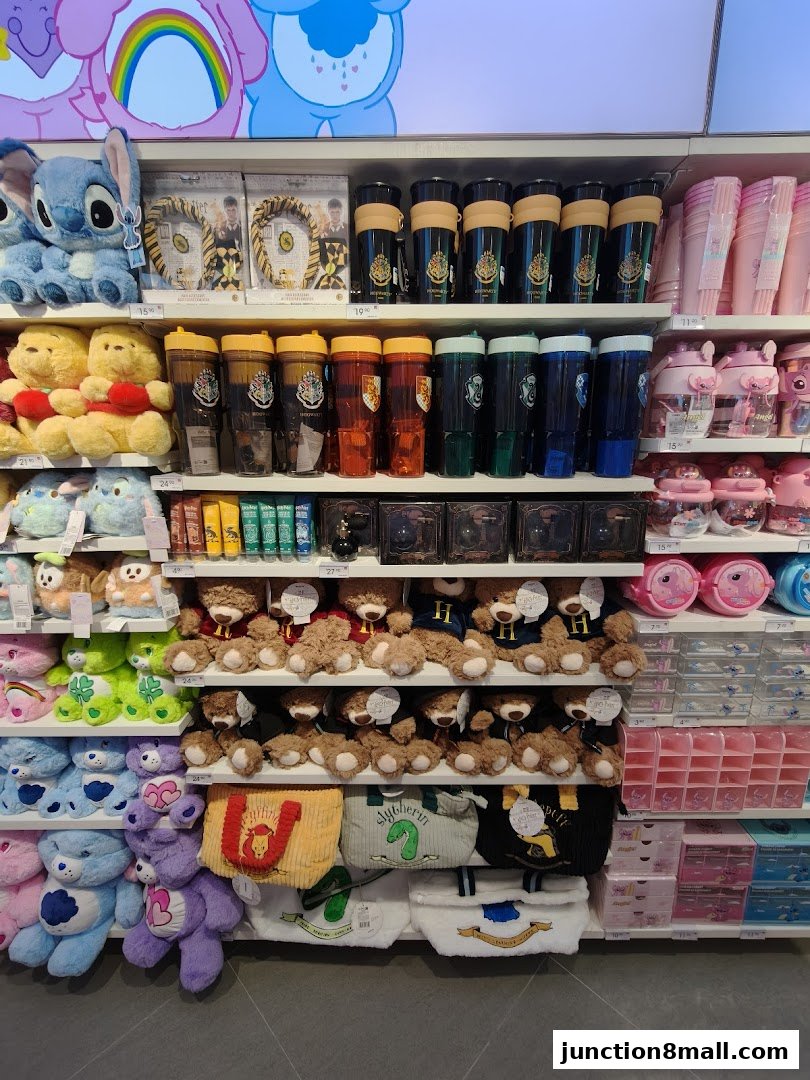 Shelves filled with plush toys, tumblers, and bags, featuring popular characters and themes.