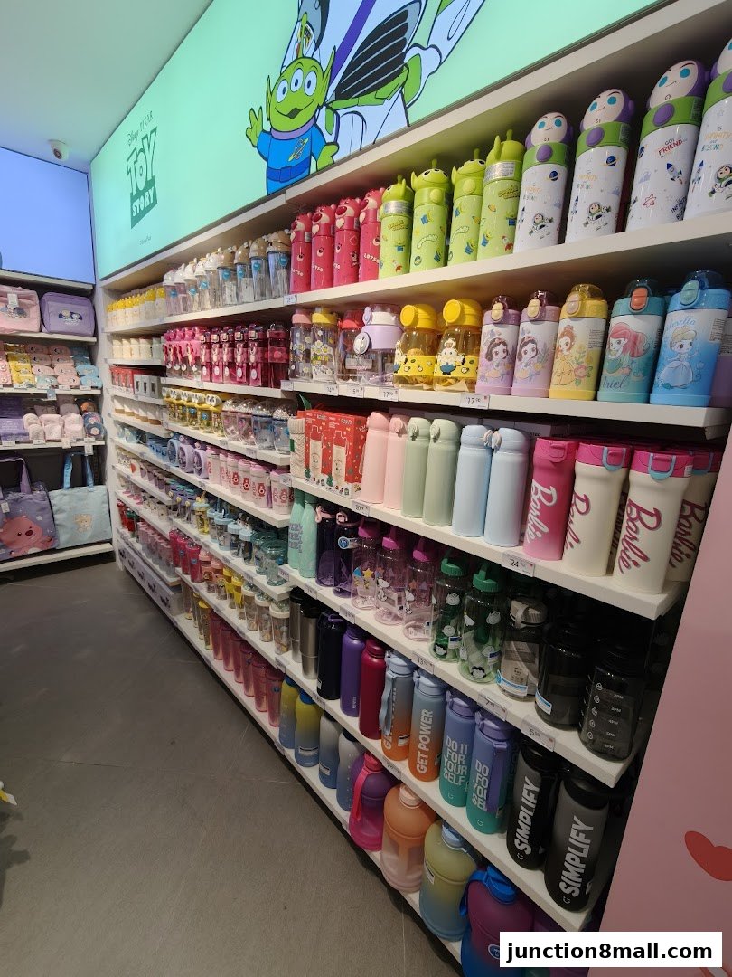 Shelves filled with colorful water bottles and drinkware, featuring popular characters like Toy Story and Barbie.