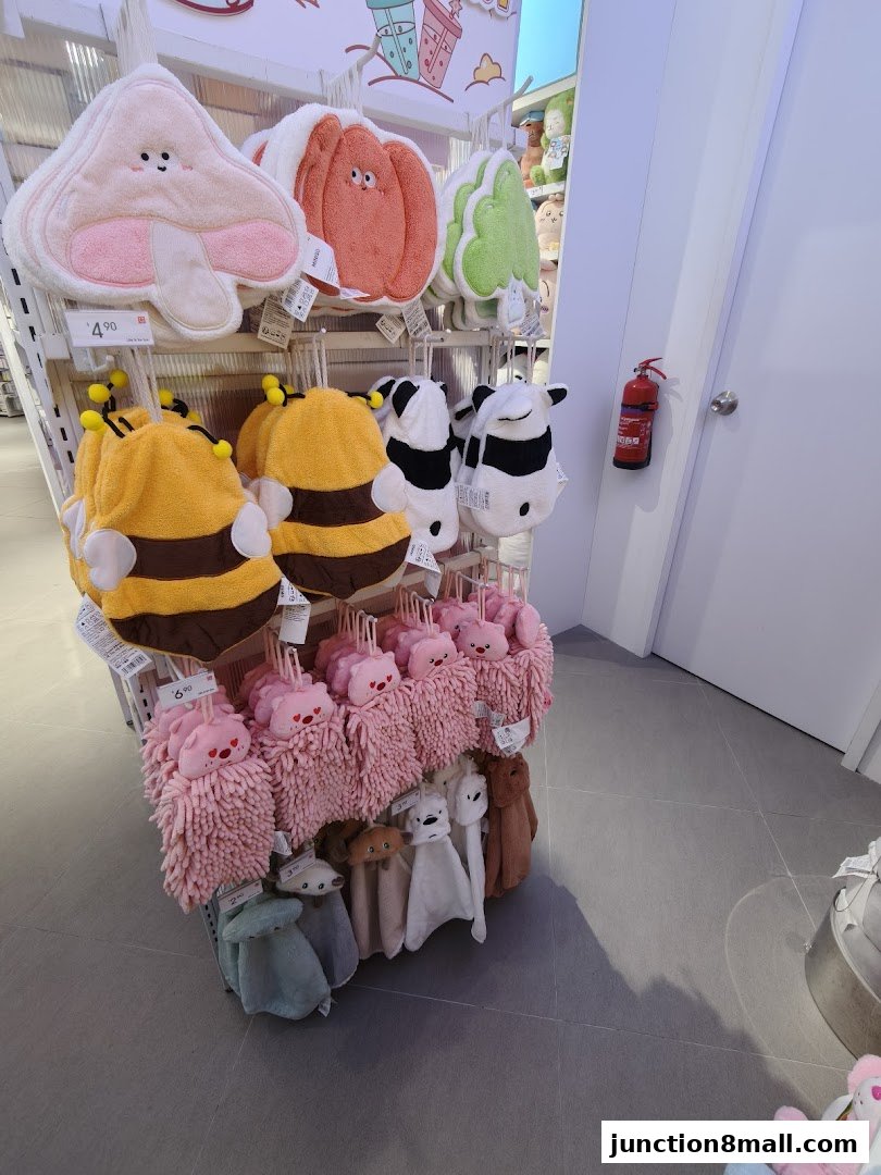 Cute plush character-themed hand towels and decorative items displayed on shelves.
