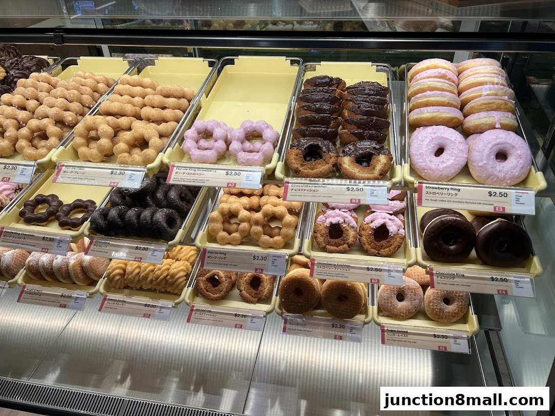 A display case filled with a variety of colorful and delicious donuts from Mister Donut.