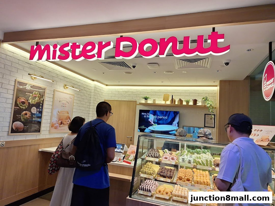 Customers browse a display of assorted donuts at Mister Donut.