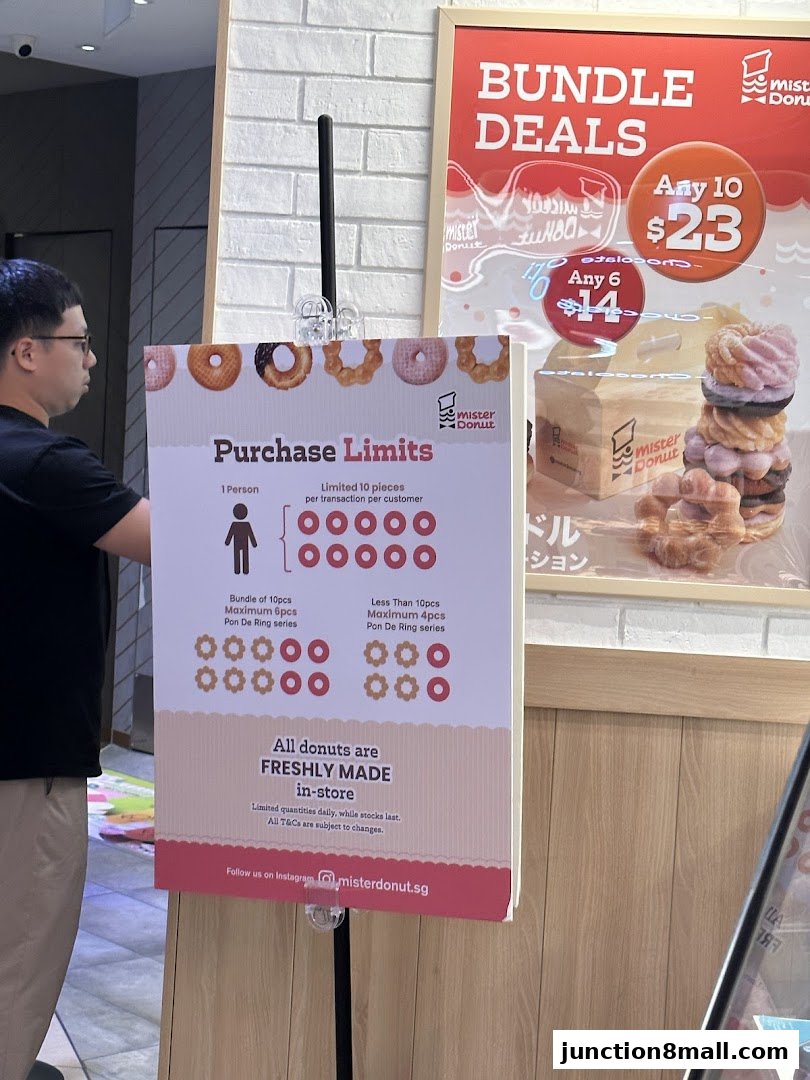 A sign detailing purchase limits and bundle deals for Mister Donut.