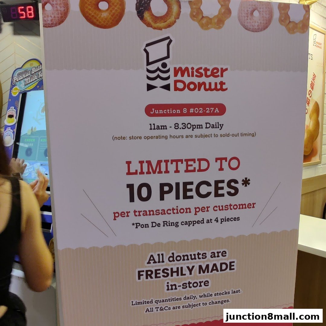 A sign for Mister Donut at Junction 8, advertising a limit of 10 pieces per customer.