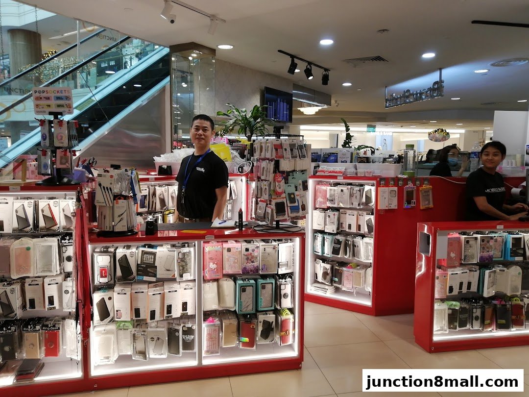 A retail shop displaying a wide variety of phone cases and accessories with staff present.