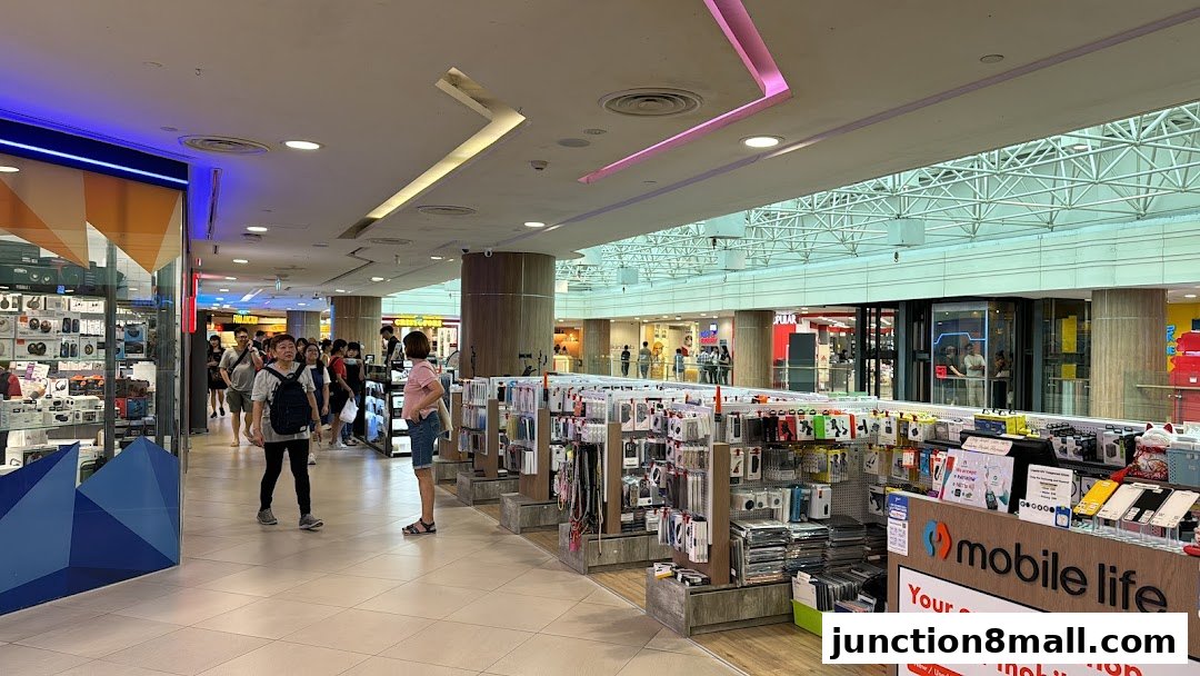 A mobile phone accessories store in a shopping mall with various phone cases and accessories displayed.