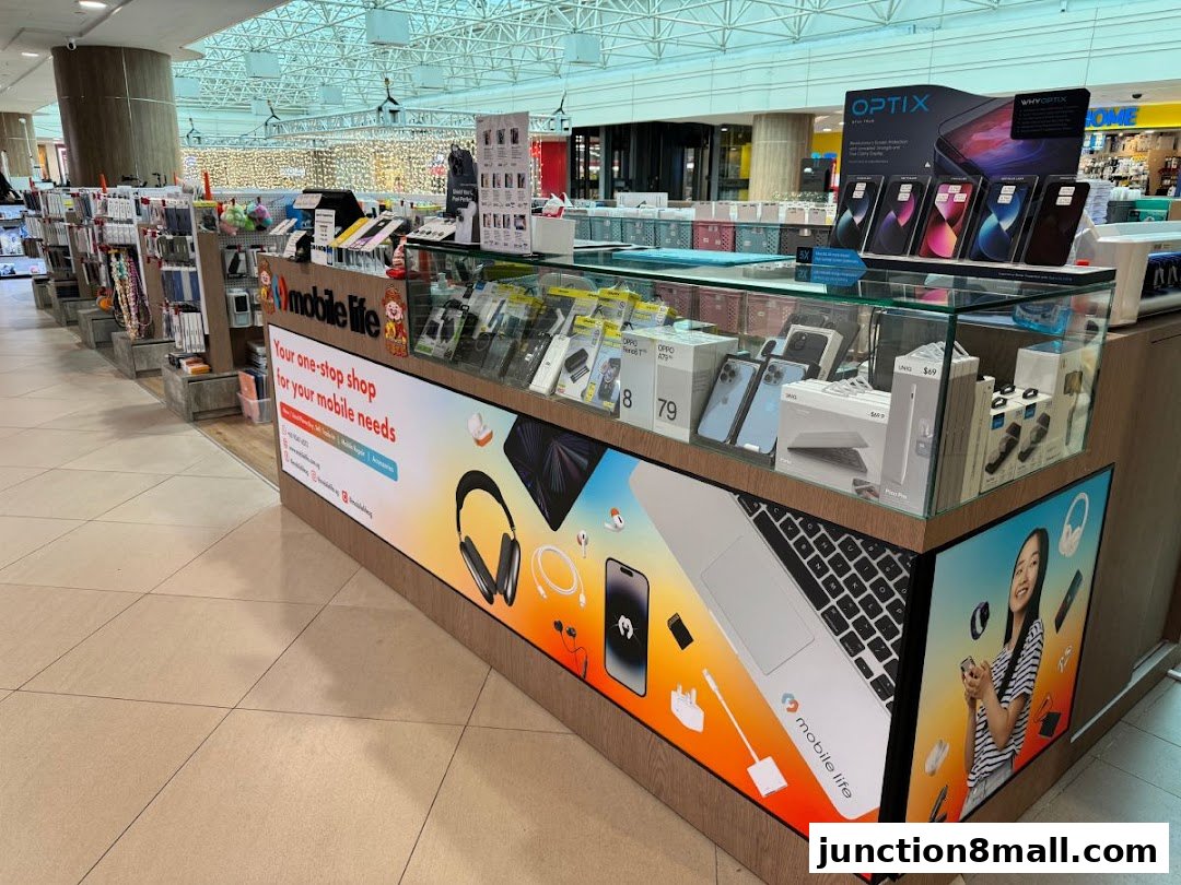 A mobile phone accessories shop display with phones, headphones, and accessories.