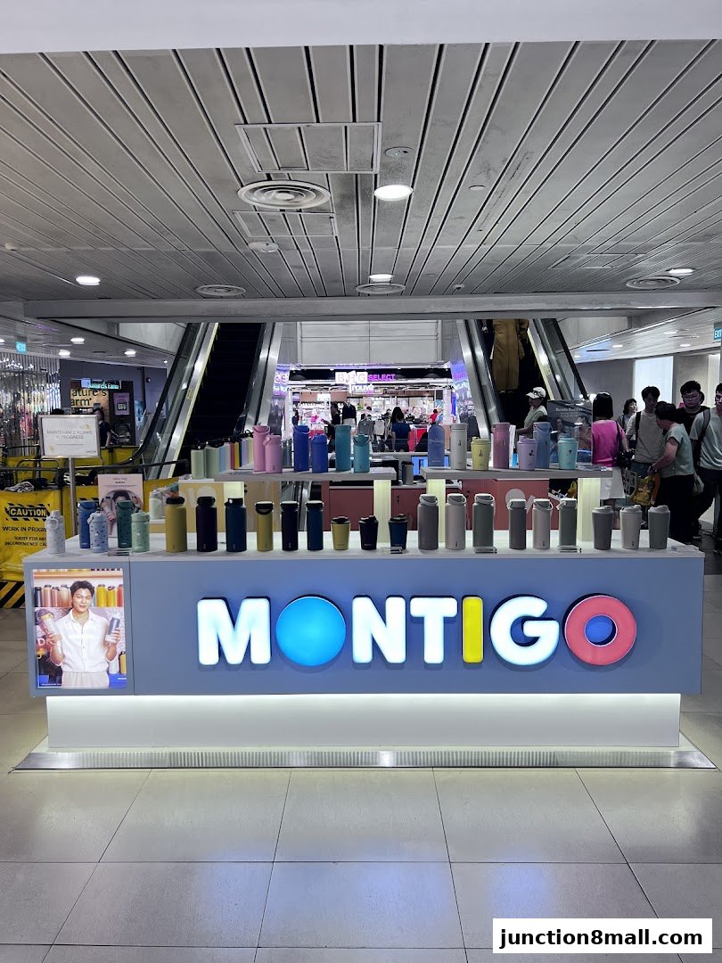 A display of Montigo water bottles in various colors and sizes in a shopping mall.