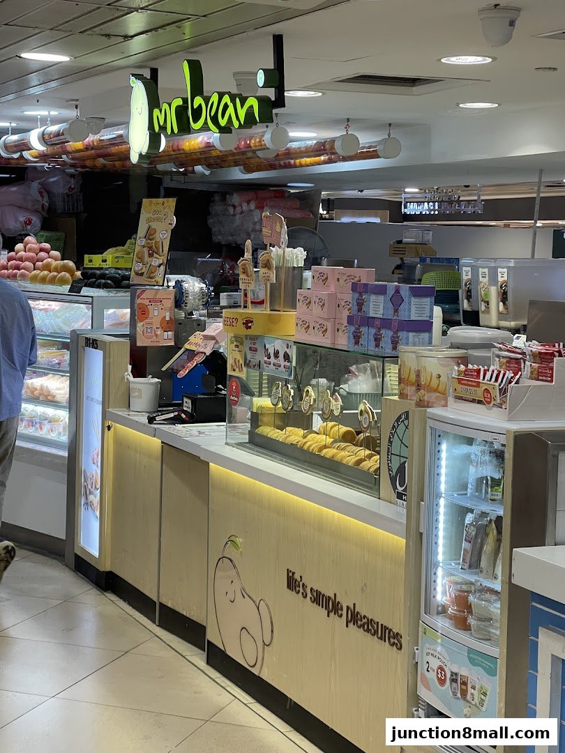The Mr Bean shop front displays baked goods, drinks, and packaged snacks.