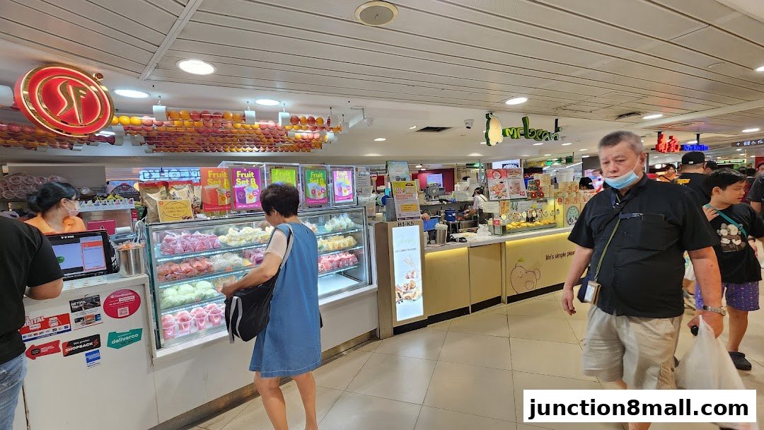 People are seen at a dessert shop with colorful displays of food and drinks.