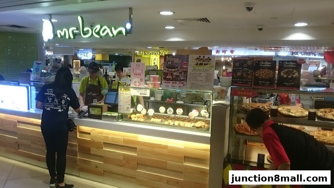 Mr Bean shop with staff serving customers and displaying food items.