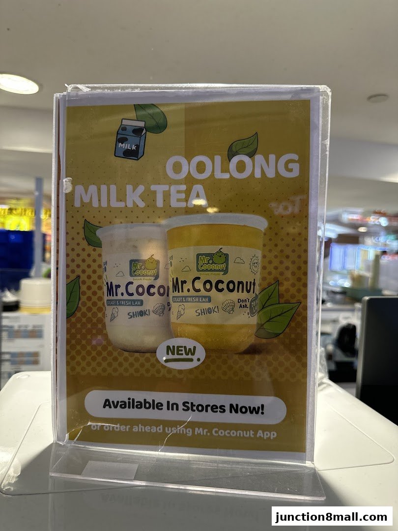 A sign advertising Mr. Coconut's Oolong Milk Tea, highlighting its new availability.