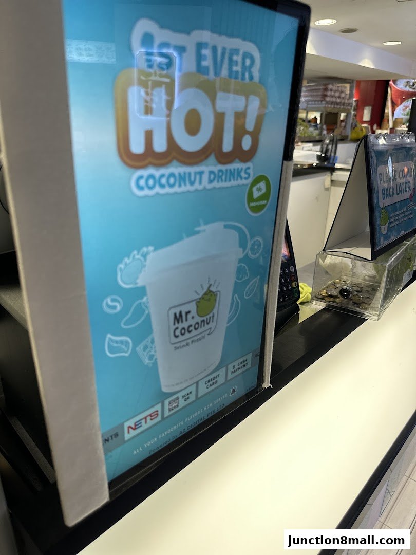 A sign for Mr. Coconut drinks featuring a cup and payment options.