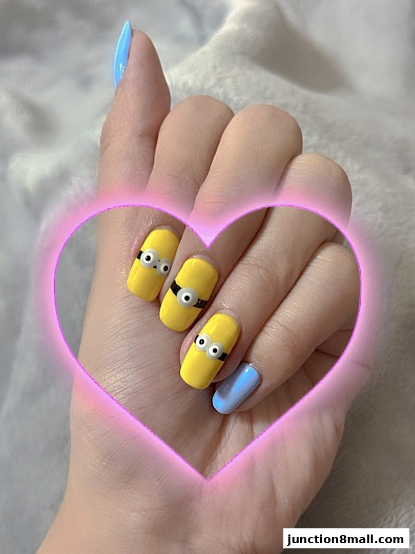 A hand with Minion-themed yellow and blue nails, framed by a pink heart.