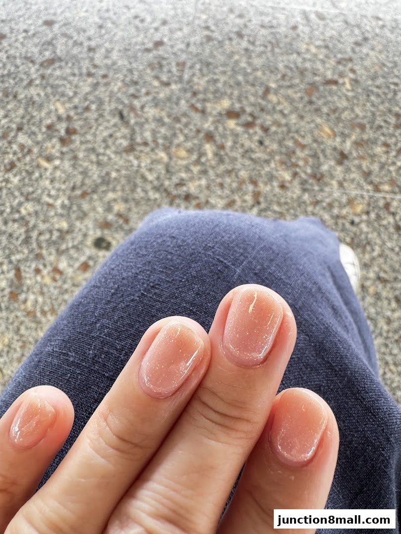 Close-up of a person's hands with neatly manicured, natural-looking nails.