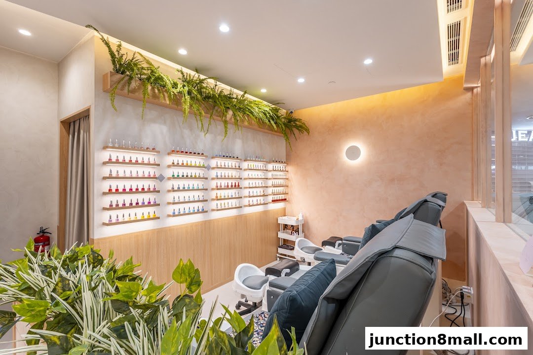 Interior of a nail salon with pedicure chairs, shelves of nail polish, and plants.