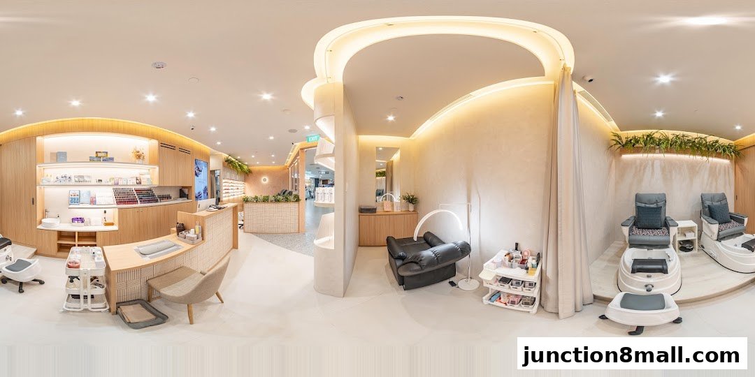 Interior view of a modern nail salon with manicure stations and pedicure chairs.